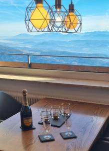 a bottle of wine sitting on a table with glasses at Erholungskanzel Top 75 in Treffen