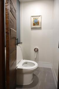 a bathroom with a toilet with a picture on the wall at Mata villa มาตา วิลล่า in Chiang Mai +90 photos