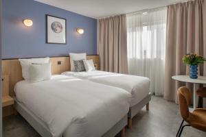 Sevenline Purpan Toulouse客房内的一张或多张床位