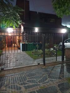 a fence in front of a building at night at departamento de 1 ambiente planta alta in Mar del Plata