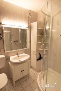 a bathroom with a sink and a shower and a toilet at 49 Ferienwohnung NEU am Südstrand Fehmarn 4U App.64-212 in Burgtiefe auf Fehmarn 