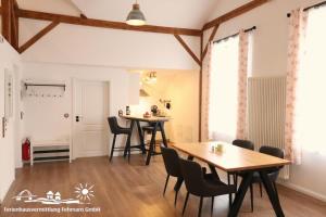 a dining room with two tables and chairs at 13 Ferienwohnung Exklusives Loft in Burg auf Fehmarn