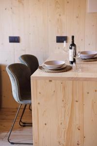 a table with two chairs and a bottle of wine at Cervino loft in Breuil-Cervinia +28 photos