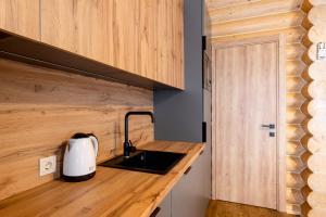 a kitchen with a counter top with a tea kettle at Готельний комплекс Парламент, Яблуниця in Yablunytsya