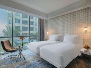 Voodi või voodid majutusasutuse Pullman Jakarta Central Park toas