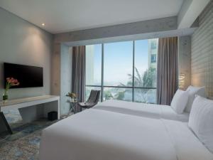 Voodi või voodid majutusasutuse Pullman Jakarta Central Park toas