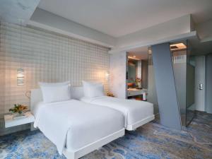 Voodi või voodid majutusasutuse Pullman Jakarta Central Park toas