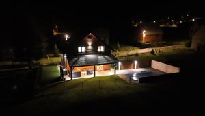 a small house with a swimming pool at night at Villa Kum in Tuk Vojni