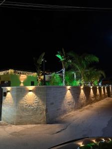 a stone wall with lights on it at night at Morgana Sea in Catania +40 photos