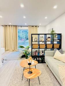 a living room with a couch and a table at Cozy private backyard garden studio in Pickering