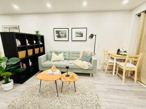 a living room with a couch and a table at Cozy private backyard garden studio in Pickering