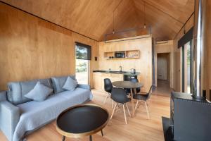 a living room with a couch and a table at Refugios Pura vida in La Paloma +64 photos
