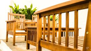 two wooden chairs and a table on a balcony at Escapada Rural en La Casa del Árbol in Tózar