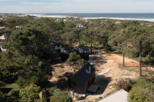 an aerial view of a house with the ocean in the background at Refugios Pura vida in La Paloma
