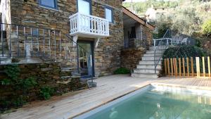 a house with a swimming pool next to a building at Varanda do Brejo in Seia