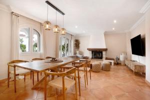 a dining room with a table and chairs and a fireplace at La casita del mar in Torremolinos