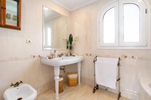 a white bathroom with a sink and a toilet at La casita del mar in Torremolinos +28 photos