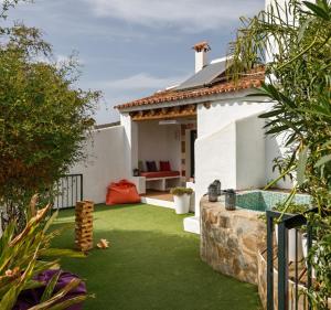 a house with a yard with green grass at Casa Verde, charming village house, 4 bedrooms in Sanlúcar de Guadiana