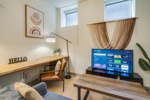 a living room with a tv and a couch at Bright and Modern Studio in Louisville # 109 in Louisville