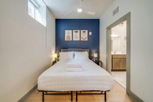 a bedroom with a large bed with a blue wall at Bright and Modern Studio in Louisville # 109 in Louisville