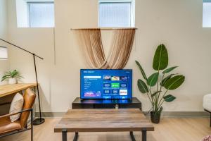 a laptop computer sitting on a table in a living room at Bright and Modern Studio in Louisville # 109 in Louisville +49 photos
