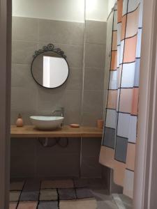 a bathroom with a sink and a mirror at loft in Pýrgos