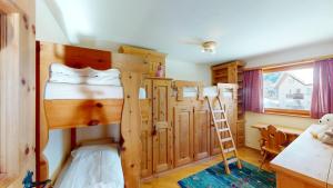 a bedroom with two bunk beds and a ladder at Apartment Ambretta OG in Champfer