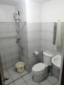 a bathroom with a toilet and a sink at Casa Mira Guadalupe Harmony Home Cebu City in Cebu City