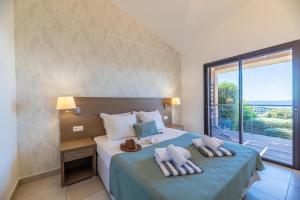 a bedroom with a bed with a large window at Résidence Les Terrasses de Rondinara in Bonifacio