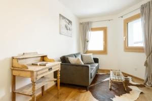 a living room with a couch and a table at Apartment Arsa 14 in Silvaplana