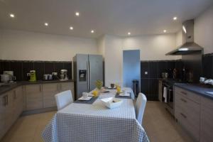 a kitchen with a table and chairs in a kitchen at Maison jasmin Porto Vecchio in Porto-Vecchio