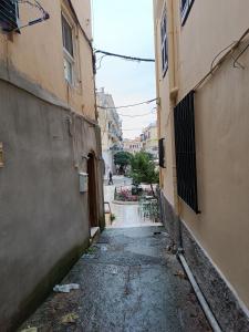 an alley way with buildings in a city at Tatiana's Town Studio in Corfu +10 photos