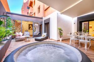 a house with a hot tub in the middle of a yard at Villa YOGA Guéliz Centre-Ville in Marrakech