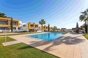 a swimming pool in front of a villa at Albufeira Sunny Apartment 3 With Pool by Homing in Albufeira