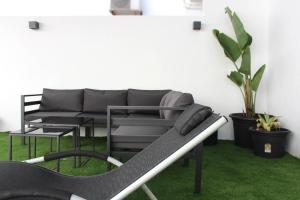 a black couch sitting in a room with green grass at Hacienda Club Benalup in Benalup Casas Viejas