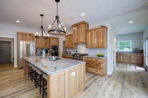 a kitchen with wooden cabinets and a large island at Majestic Manor-Private Hundred Acre Yard-Pool/Spa in Lebanon