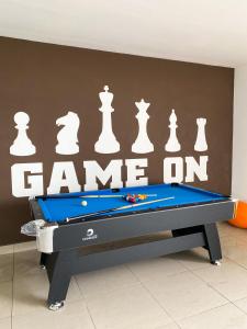 a pool table in front of a wall with chess pieces at Veranda-2BR,4pax I 5mins to CIQ and KSL I Fast-Wifi in Johor Bahru +77 photos
