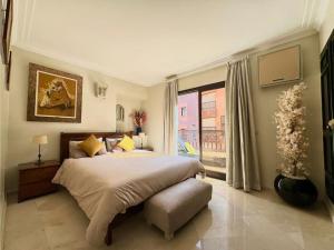a bedroom with a large bed and a window at Piscine Guéliz Center Yoga in Marrakech +14 photos