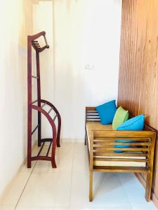 a bench with pillows and a chair in a room at YOUTHENI VILLA in Weligama