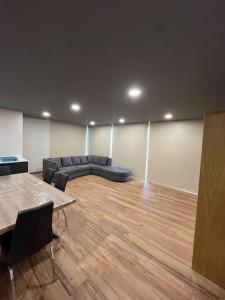 a living room with a couch and a wooden floor at Sunset Valley House in Ribeira Brava