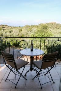 a table and chairs on a balcony with a view at Villa Sunrise apartment in Gouvia