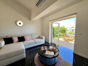 a living room with a couch and a table at Albufeira Stylish 3 by Homing in Albufeira