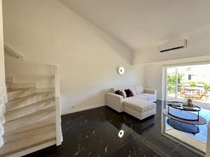 a living room with a couch and a table at Albufeira Stylish 3 by Homing in Albufeira