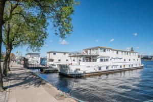 a large white boat is docked in the water at Rygerfjord Hotel & Hostel in Stockholm