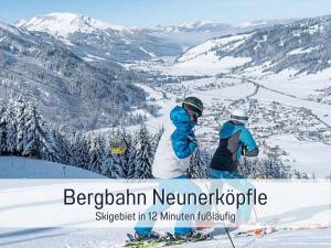 two people standing on top of a snow covered mountain at Apartments Tannheim - bei Birgit Mariacher - inklusive Sommerbergbahnen - Infrarotsauna & Brötchenservice - zentral mit Bergblick in Tannheim +67 photos