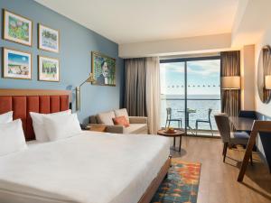 a hotel room with a bed and a desk at Sundia Exclusive By Liberty Fethiye Adults Only in Fethiye