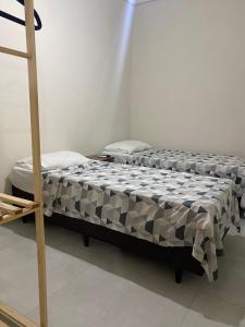 two beds in a room with a ladder at Top Coliving II in Cuiabá +8 photos