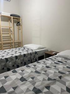 a room with two beds in a room at Top Coliving II in Cuiabá