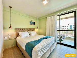 a bedroom with a large bed and a balcony at Condomínio Mediterranee Residence por Be My Guest in Aquiraz +291 photos