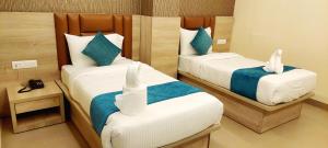 Postel nebo postele na pokoji v ubytování Hotel Ananda Kashi